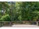 Over-sized wooden deck surrounded by lush trees, perfect for outdoor relaxation and entertaining at 10616 Back Ridge Rd, Charlotte, NC 28277
