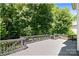 Expansive wooden deck surrounded by lush trees, perfect for outdoor relaxation and entertaining at 10616 Back Ridge Rd, Charlotte, NC 28277