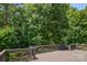 Over-sized wooden deck surrounded by lush trees, perfect for outdoor relaxation and entertaining at 10616 Back Ridge Rd, Charlotte, NC 28277