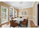 Elegant dining room with a chandelier, large windows, and seating for eight at 10616 Back Ridge Rd, Charlotte, NC 28277