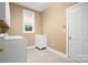 Functional laundry room with a utility sink, window, and washer/dryer hookups at 10616 Back Ridge Rd, Charlotte, NC 28277