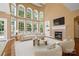 Bright living room boasts a fireplace, large windows, and soaring ceilings at 10616 Back Ridge Rd, Charlotte, NC 28277