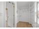Bright walk-in closet has built-in shelving and hanging rods for optimal storage at 10616 Back Ridge Rd, Charlotte, NC 28277