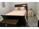 Traditional bedroom with a wooden sleigh bed, decorative pillows, and a side table with a lamp at 1119 Balls Creek Rd, Claremont, NC 28610