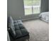 Comfortable bedroom with a futon, neutral carpet, and large window offering ample natural light at 1119 Balls Creek Rd, Claremont, NC 28610