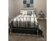Serene bedroom featuring a wrought iron bed frame with blue and white striped bedding at 1119 Balls Creek Rd, Claremont, NC 28610
