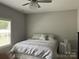 Cozy bedroom with neutral colors and a decorative chandelier at 1119 Balls Creek Rd, Claremont, NC 28610