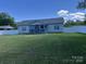 Charming single-story home with a well-manicured lawn and a covered porch at 1119 Balls Creek Rd, Claremont, NC 28610