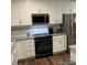 Modern kitchen featuring stainless steel appliances, granite countertops, and stylish white cabinets at 1119 Balls Creek Rd, Claremont, NC 28610