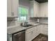 Beautiful kitchen featuring granite countertops, stainless steel appliances, and white cabinetry at 1119 Balls Creek Rd, Claremont, NC 28610