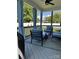 Inviting covered patio with comfortable seating, privacy curtains, and ceiling fan at 1119 Balls Creek Rd, Claremont, NC 28610