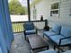 Screened porch showcasing stylish outdoor furniture and a view of the backyard at 1119 Balls Creek Rd, Claremont, NC 28610