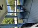 Covered porch features comfortable seating with blue cushions and a ceiling fan at 1119 Balls Creek Rd, Claremont, NC 28610