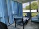 View of the screened porch with comfortable seating and view of the backyard at 1119 Balls Creek Rd, Claremont, NC 28610