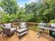Cozy deck with outdoor seating, a grill, and lush green surroundings, ideal for summer gatherings at 1300 Rutledge Ave, Charlotte, NC 28211