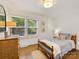 Cozy bedroom with hardwood floors, a dresser, and natural light creates a warm and inviting atmosphere at 1300 Rutledge Ave, Charlotte, NC 28211