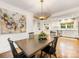 Dining room with stainless appliances, hardwood floors, a stylish chandelier and access to the kitchen at 1300 Rutledge Ave, Charlotte, NC 28211