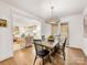 Elegant dining room featuring hardwood floors, a modern chandelier, and an open flow to the living area at 1300 Rutledge Ave, Charlotte, NC 28211