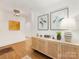 Tastefully decorated entryway with hardwood floors, modern light fixture, and stylish console table at 1300 Rutledge Ave, Charlotte, NC 28211