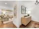 Bright entryway featuring hardwood floors, stylish console table with decor, and artwork at 1300 Rutledge Ave, Charlotte, NC 28211