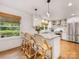Bright kitchen with an island, stainless appliances, and hardwood floors exudes a modern charm at 1300 Rutledge Ave, Charlotte, NC 28211