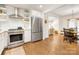 Modern kitchen features stainless steel appliances and opens into a dining area with hardwood floors at 1300 Rutledge Ave, Charlotte, NC 28211