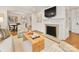 Bright living room featuring a fireplace, hardwood floors, and an open layout to the dining area at 1300 Rutledge Ave, Charlotte, NC 28211