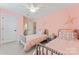 Charming pink bedroom featuring two twin beds and light grey accents at 1328 Huntcliff Dr, Waxhaw, NC 28173