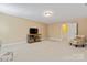 Bonus room with TV, neutral walls, carpeted floor, and an accent chair at 1328 Huntcliff Dr, Waxhaw, NC 28173
