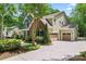 Exterior view of a home showcasing a spacious driveway leading to the garage and a well-maintained landscaped yard at 1328 Huntcliff Dr, Waxhaw, NC 28173