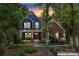 Charming two-story home featuring a mix of brick and blue siding, a welcoming porch, and lush landscaping at 1328 Huntcliff Dr, Waxhaw, NC 28173