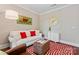 Comfortable sitting area featuring a plush sofa with red pillows, a vintage sign, and a decorative trunk table at 1328 Huntcliff Dr, Waxhaw, NC 28173