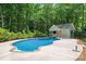 Sparkling backyard pool with a pool house and lush greenery at 1328 Huntcliff Dr, Waxhaw, NC 28173