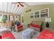Covered porch features cozy seating, perfect for relaxing and enjoying the outdoors in comfort at 1328 Huntcliff Dr, Waxhaw, NC 28173