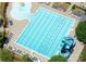 Aerial view showcases the pool with a waterslide, surrounding lounge chairs, and mature trees at 1428 Spring Ridge Ln, Denver, NC 28037