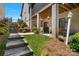 Stone steps ascend to a spacious backyard featuring a brick covered patio and landscaped gardens at 1428 Spring Ridge Ln, Denver, NC 28037