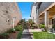 Multi-level backyard with a decorative stone stairway, lush greenery, and a patio at 1428 Spring Ridge Ln, Denver, NC 28037