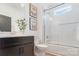Bright bathroom featuring tiled shower, modern vanity, neutral paint, and elegant butterfly wall art at 1428 Spring Ridge Ln, Denver, NC 28037