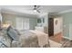 Comfortable bedroom with large windows, ceiling fan, and stylish decor at 1428 Spring Ridge Ln, Denver, NC 28037
