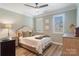 Cozy bedroom with hardwood floors, neutral decor, shuttered windows, and stylish furnishings at 1428 Spring Ridge Ln, Denver, NC 28037
