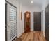 Inviting entryway with hardwood floors, a grandfather clock, and a modern door at 1428 Spring Ridge Ln, Denver, NC 28037