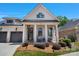 Charming brick home featuring a two-car garage, inviting front porch and landscaped front yard at 1428 Spring Ridge Ln, Denver, NC 28037