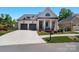 Charming brick home featuring a two-car garage, inviting front porch and landscaped front yard at 1428 Spring Ridge Ln, Denver, NC 28037