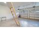 Spacious two car garage with high ceilings and an attic access ladder at 1428 Spring Ridge Ln, Denver, NC 28037