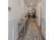 Inviting hallway with wood floors, decorative console table, and a view of the living room with a stone fireplace at 1428 Spring Ridge Ln, Denver, NC 28037