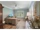Light-filled home office features a ceiling fan, plantation shutters, and a spacious wooden desk and chair at 1428 Spring Ridge Ln, Denver, NC 28037