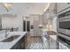 Gourmet kitchen boasts stainless steel appliances, light gray cabinets, and an island with a sink at 1428 Spring Ridge Ln, Denver, NC 28037
