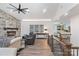 Charming living area featuring a stone fireplace, lots of seating, and seamless flow into a wet bar at 1428 Spring Ridge Ln, Denver, NC 28037