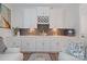 Stylish bar area with white cabinetry, dark backsplash, wine rack, and modern decor at 1428 Spring Ridge Ln, Denver, NC 28037