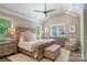 Serene main bedroom with vaulted ceiling, neutral colors, elegant furniture, and natural light at 1428 Spring Ridge Ln, Denver, NC 28037